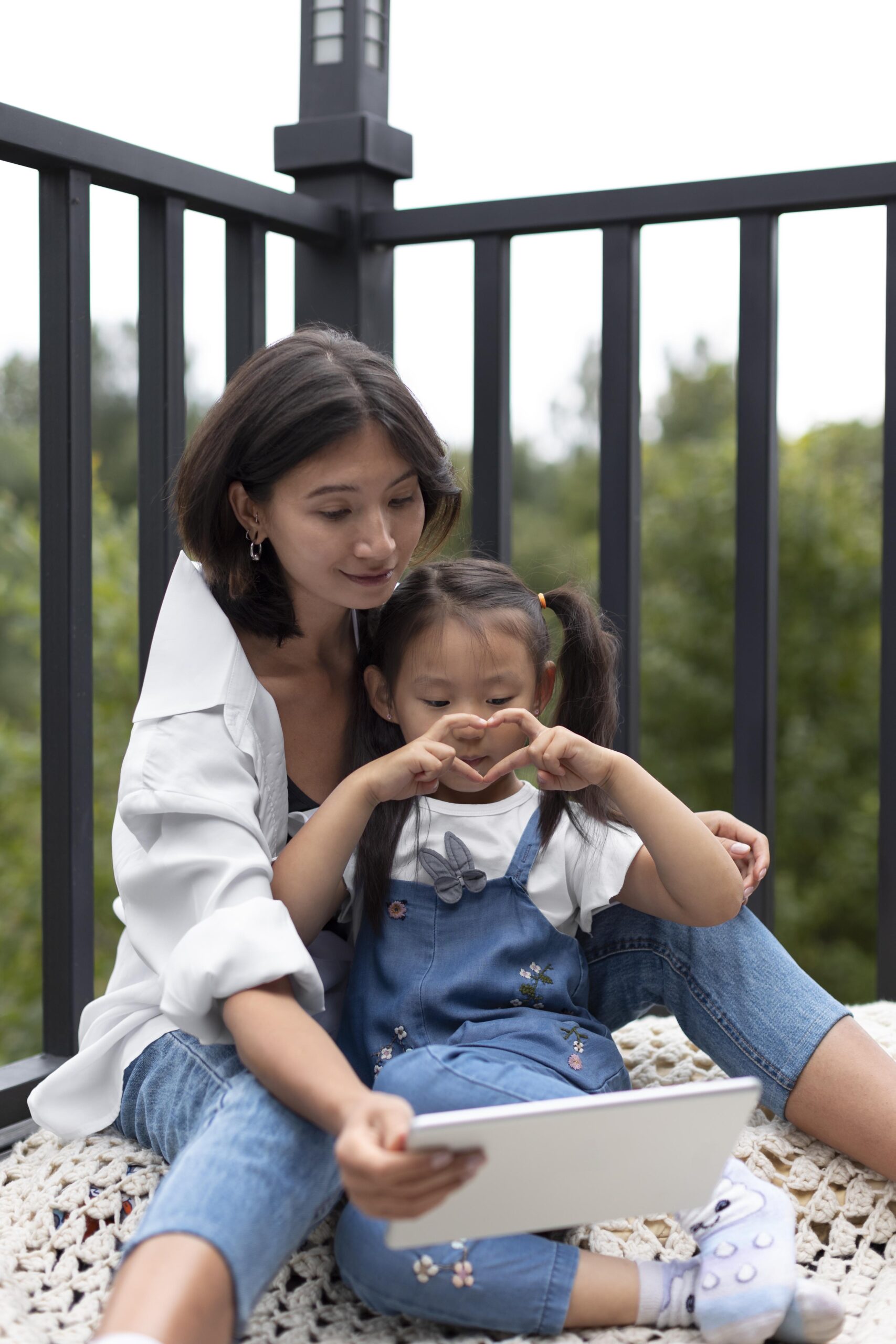 woman having video call with her husband their daughter outdoors